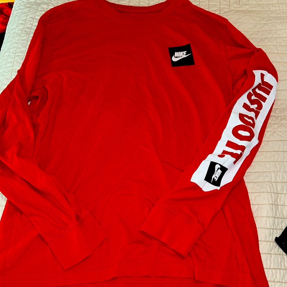 The Nike T  men’s size large 100% cotton red
